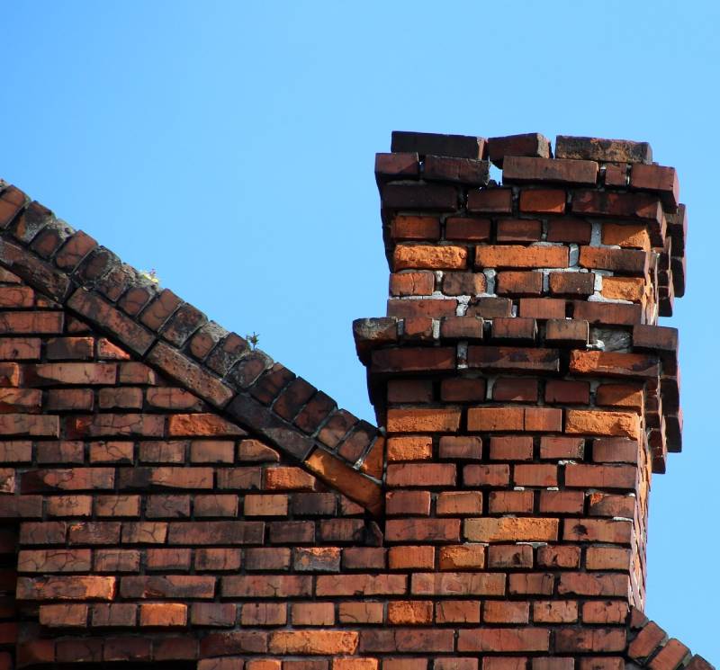 Damaged chimney on an Essex home showing cracks and missing mortar